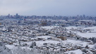 雪の富山市街地と大峪城…